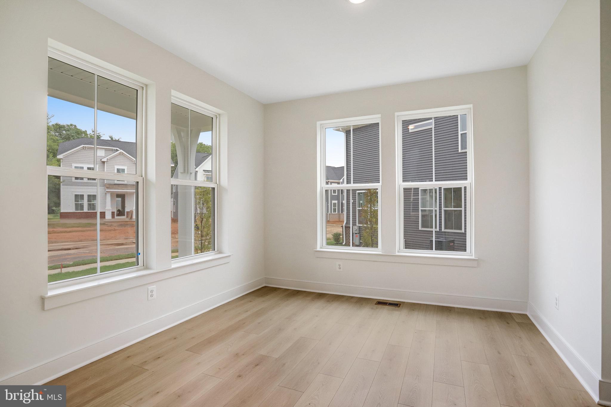 2734 Tuscarora Road Adamstown, MD 21710 - Photo 13 of 85 an empty room with wooden floor and windows
