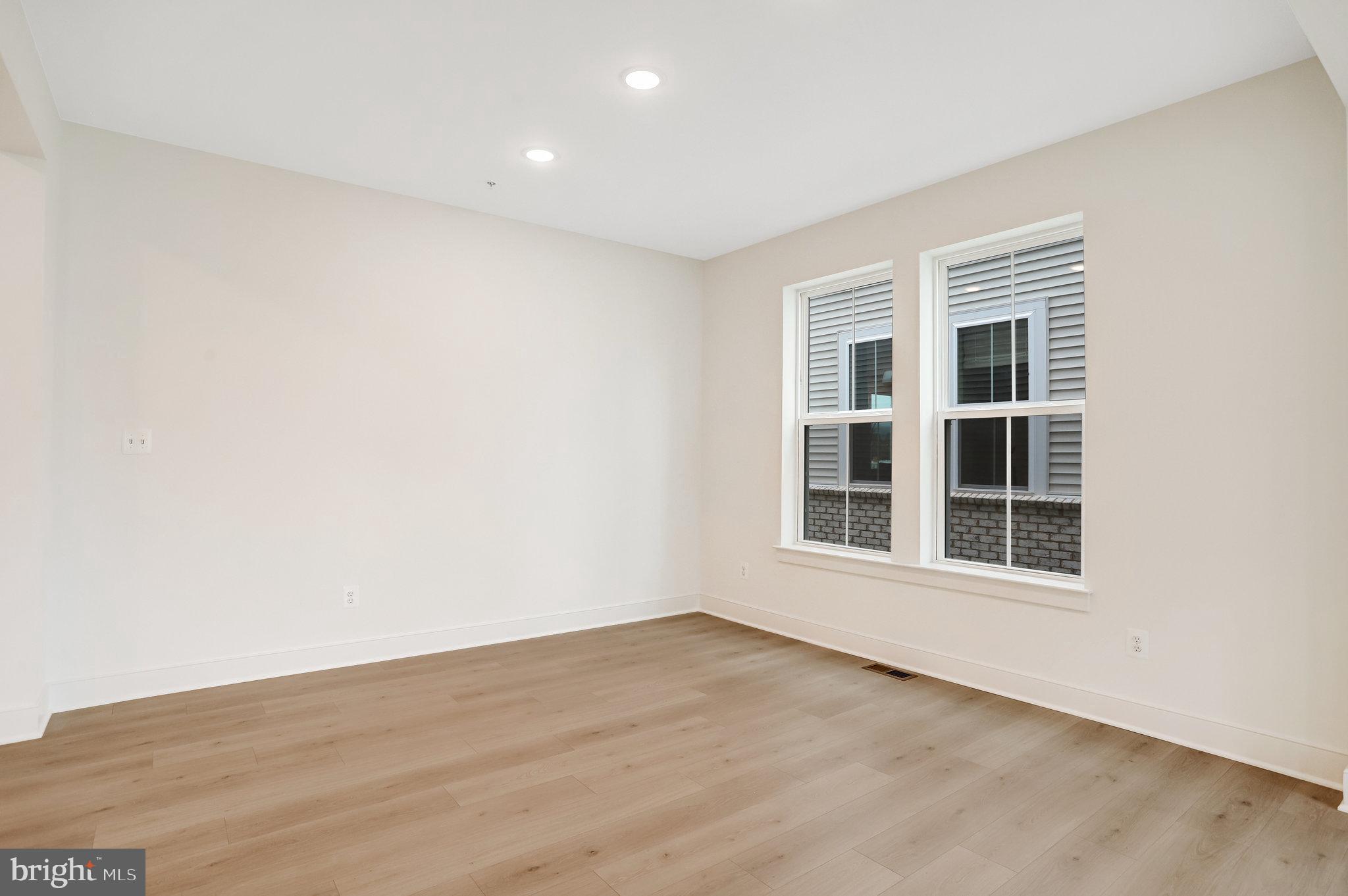 2734 Tuscarora Road Adamstown, MD 21710 - Photo 21 of 85 an empty room with wooden floor and windows