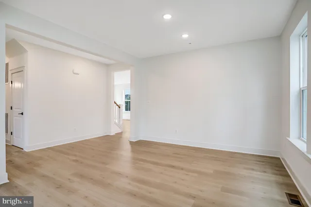 a view of a livingroom with a fireplace wooden floor and staircase