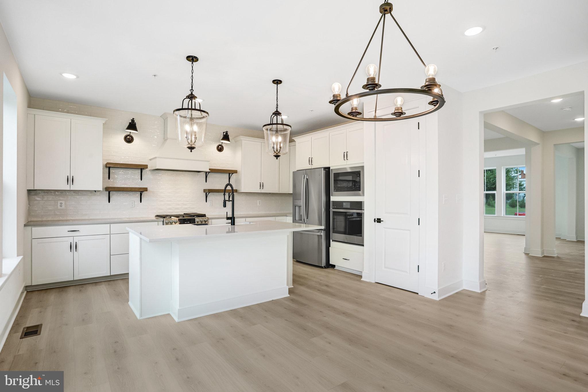 2734 Tuscarora Road Adamstown, MD 21710 - Photo 32 of 85 a kitchen with stainless steel appliances granite countertop a sink a stove a refrigerator and white cabinets
