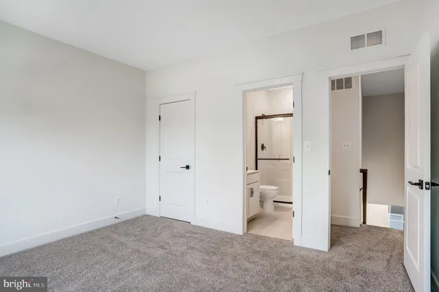 a view of an empty room with white walls