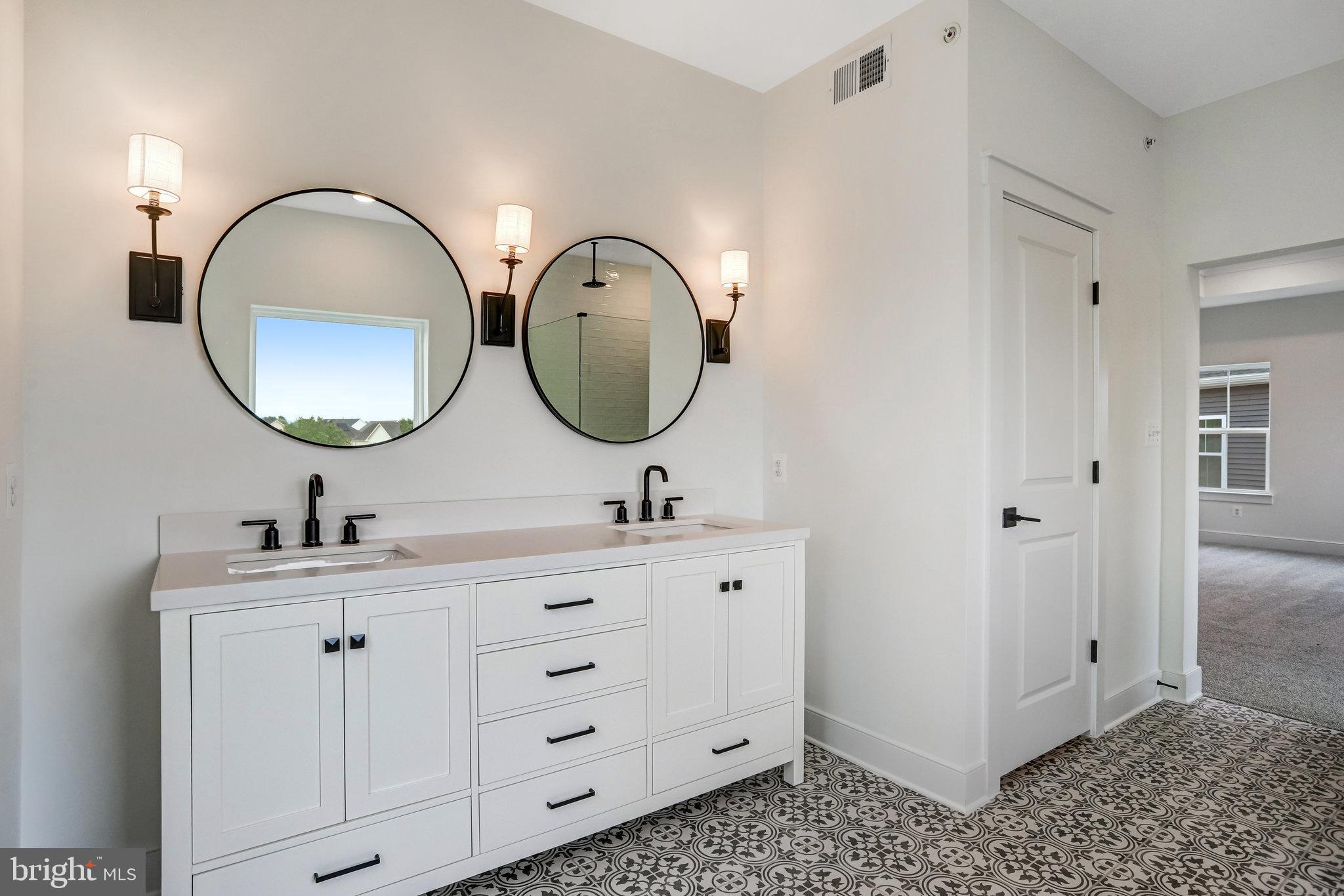 2734 Tuscarora Road Adamstown, MD 21710 - Photo 66 of 85 a bathroom with a double vanity sink and a mirror