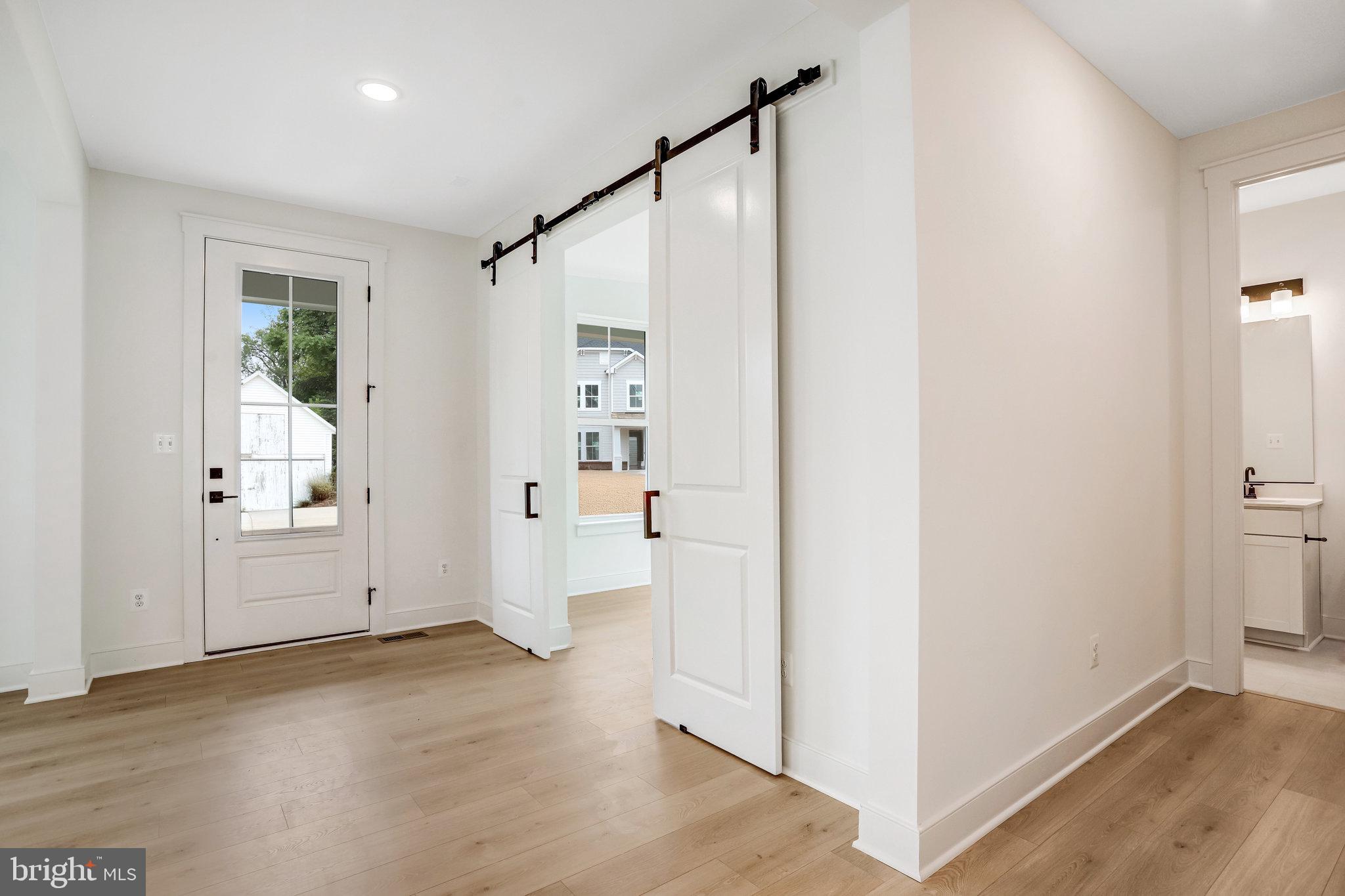 2734 Tuscarora Road Adamstown, MD 21710 - Photo 10 of 85 an empty room with wooden floor and windows