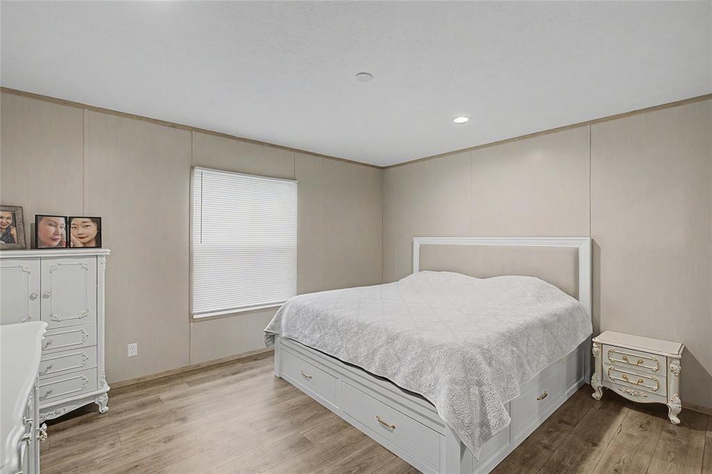6065 Timber Trail Azle, TX 76020 - Photo 14 of 33 a bedroom with a bed and wooden floor