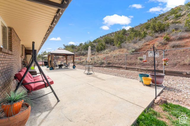 6407 North Dry Frk Cyn Road West Vernal, UT 84078 - Photo 16 of 48 View of patio / terrace featuring a gazebo, fence, and a mountain view