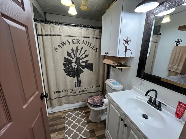 a bathroom with a sink a toilet and mirror