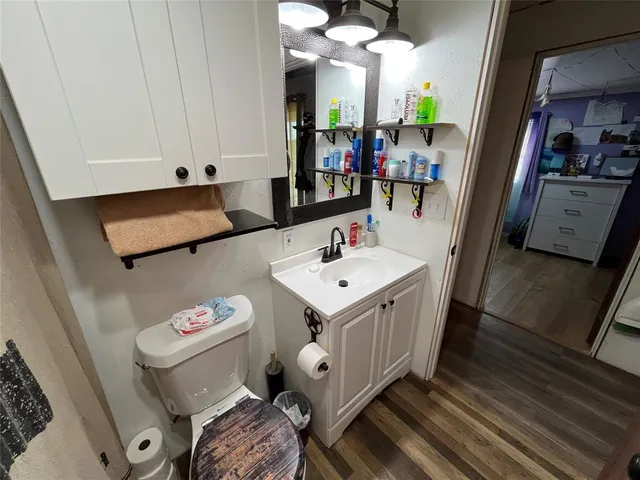 a living room with furniture a flat screen tv and gym equipment