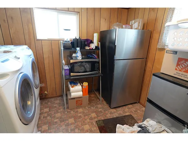 a bedroom with a bed a window and shower