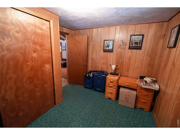 a view of a terrace with a dining table and chairs with wooden fence