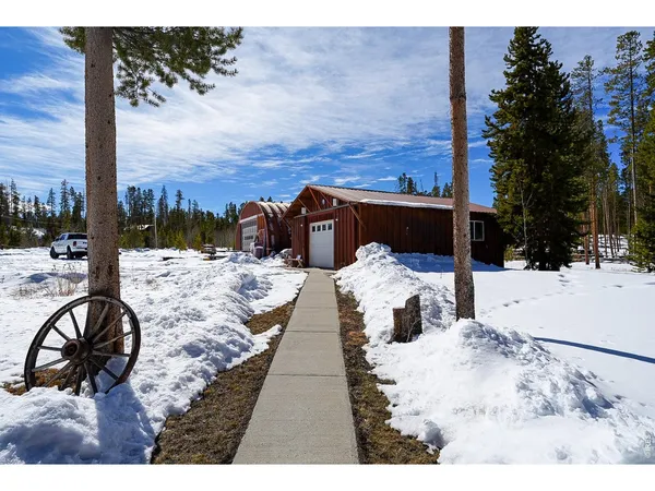 a street view with residential house and trees in the background