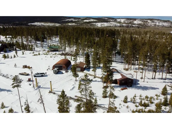 a view of swimming pool with a table and chairs under an umbrella