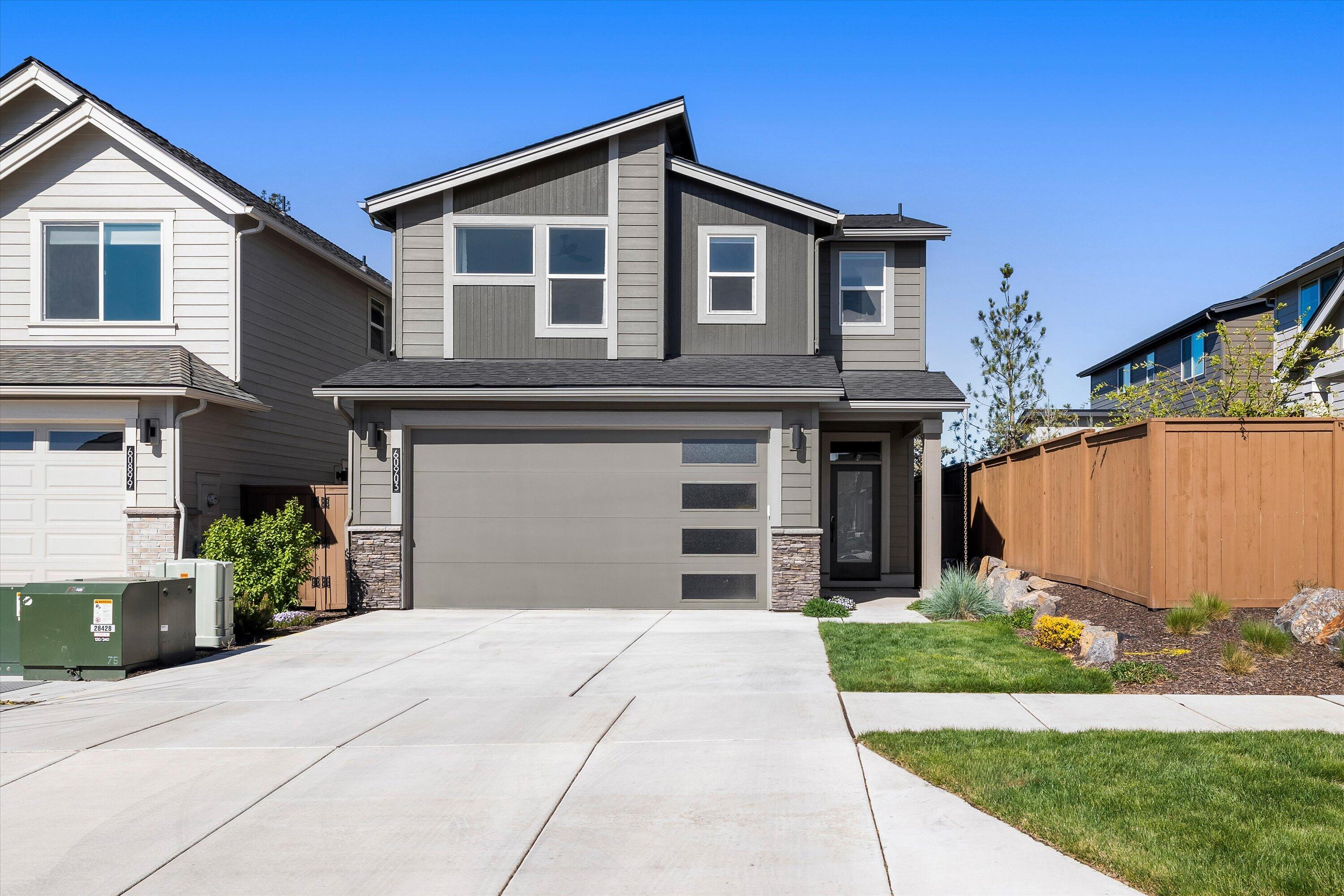 60903 Southeast Epic Place Bend, OR 97702 - Photo 1 of 48 a front view of a house with a yard and garage