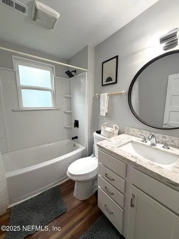 a view of staircase with lots of frames on wall and a rug