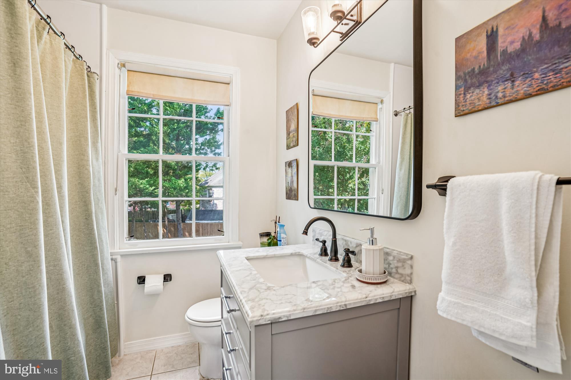 6108 Dorchester Street Springfield, VA 22150 - Photo 13 of 20 a bathroom with a granite countertop sink and a window