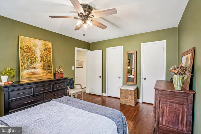 a spacious bedroom with a bed and a chandelier