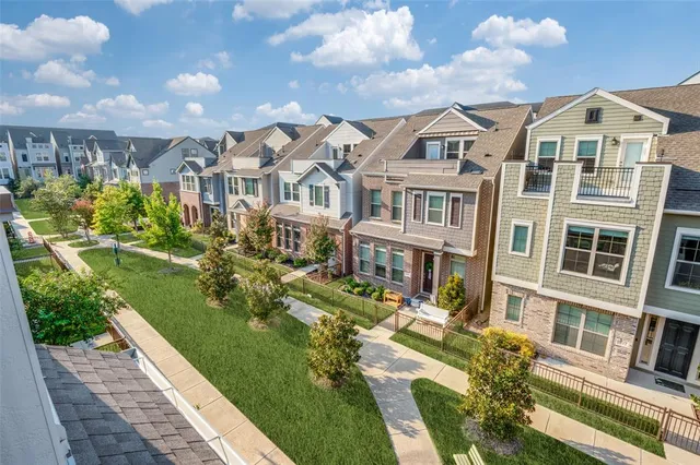 a view of a residential apartment building with a yard