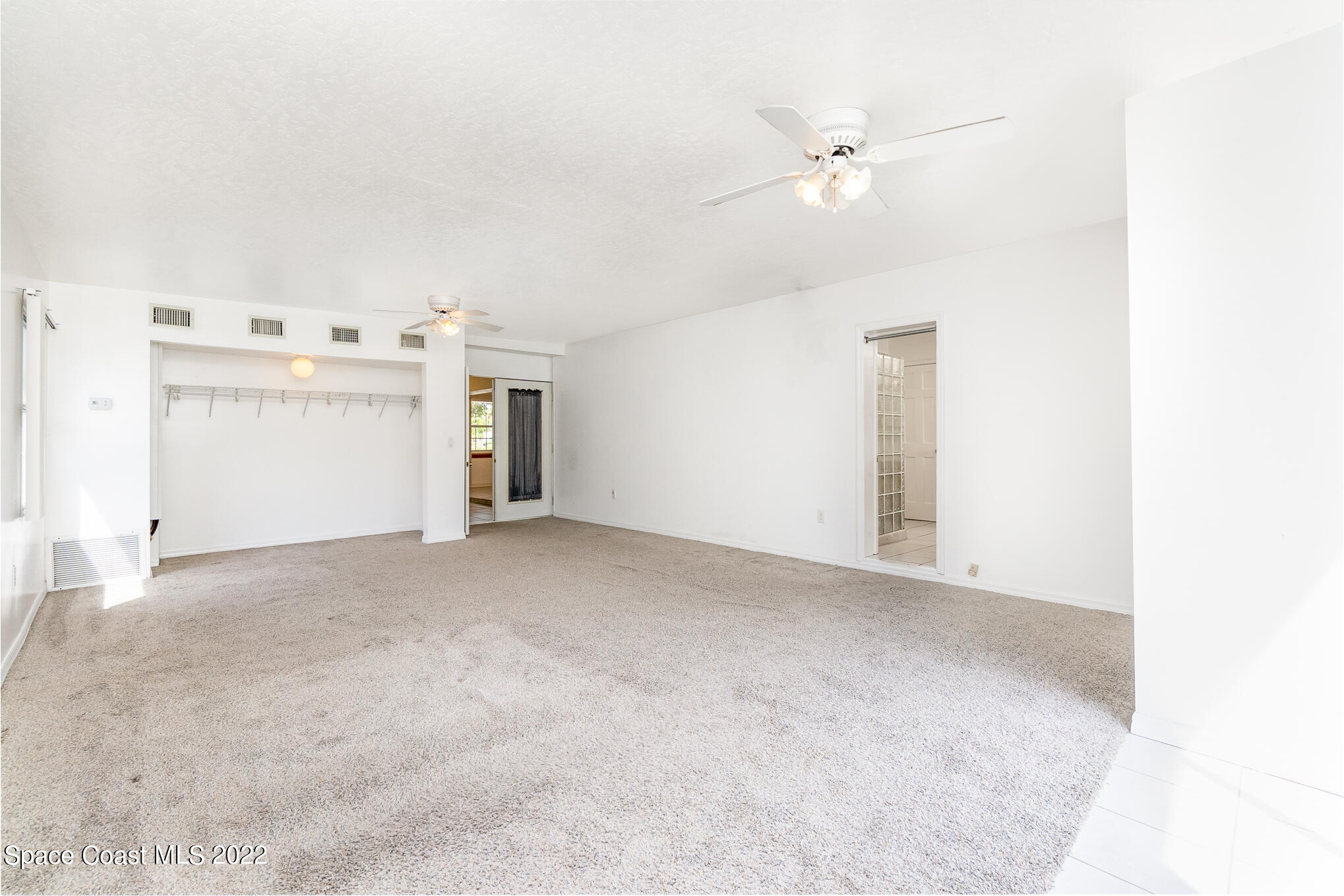 201 Orchid Boulevard Melbourne, FL 32901 - Photo 21 of 36 a view of a livingroom with a ceiling fan and window