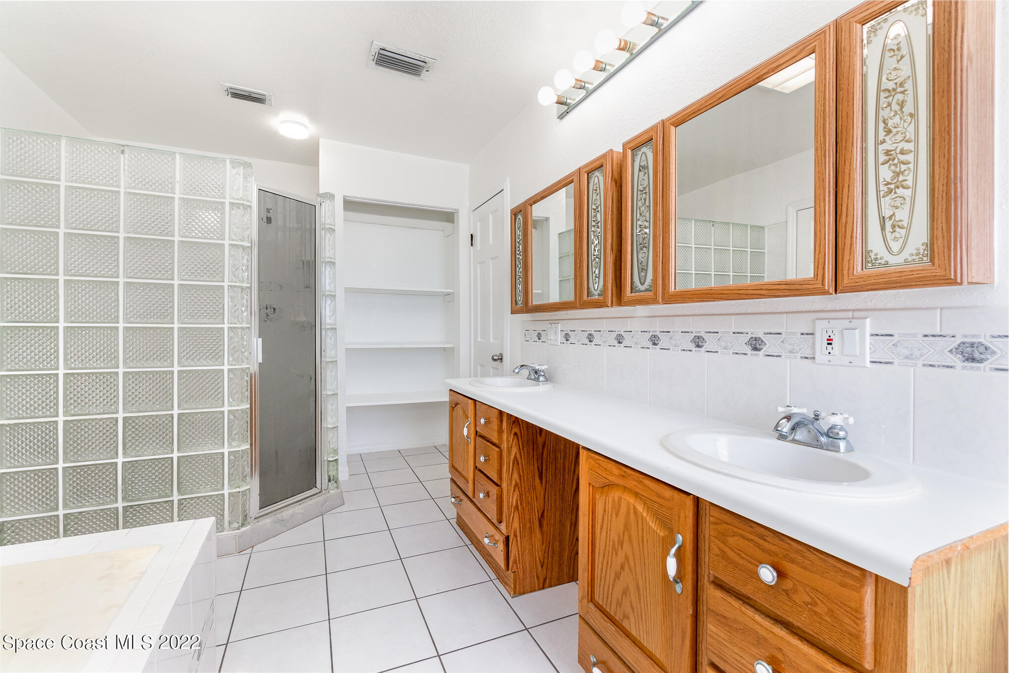 201 Orchid Boulevard Melbourne, FL 32901 - Photo 26 of 36 a bathroom with a sink a vanity and a mirror