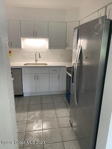 201 Orchid Boulevard Melbourne, FL 32901 - Photo 35 of 36 a kitchen with a refrigerator and a sink