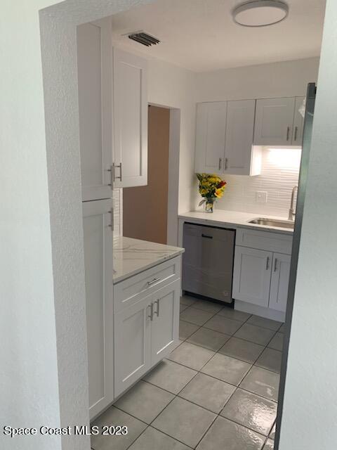 201 Orchid Boulevard Melbourne, FL 32901 - Photo 36 of 36 a kitchen with stainless steel appliances granite countertop a sink and a refrigerator