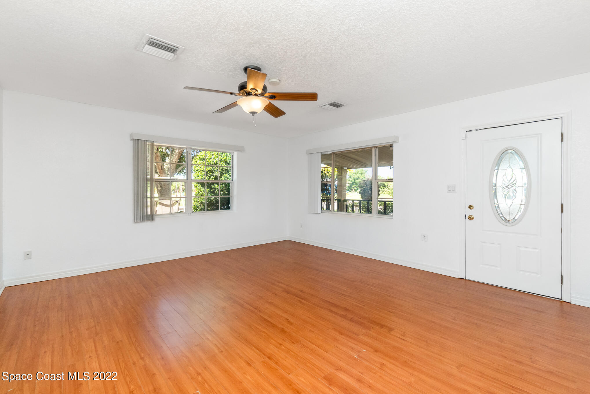 201 Orchid Boulevard Melbourne, FL 32901 - Photo 4 of 36 a view of empty room with wooden floor