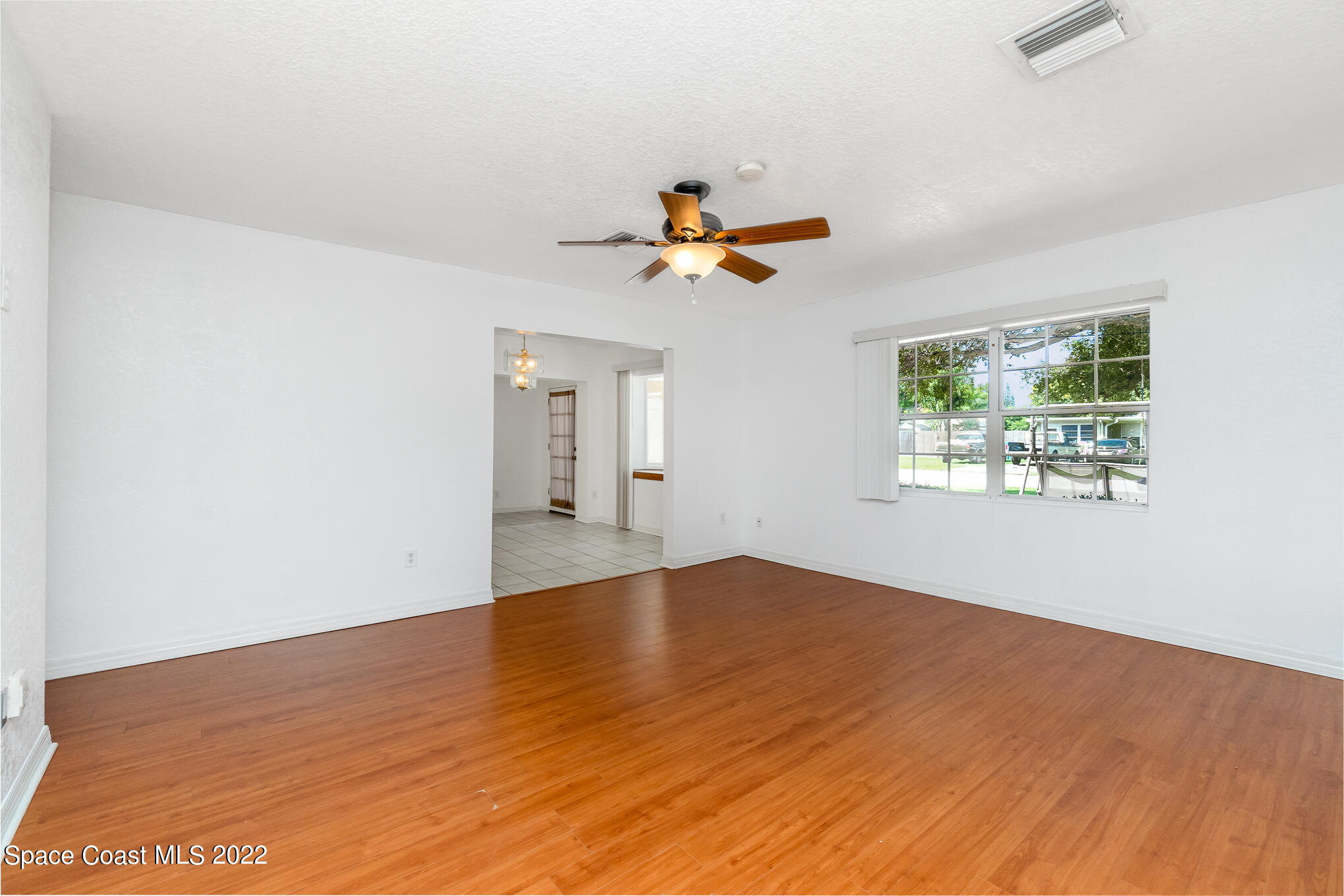 201 Orchid Boulevard Melbourne, FL 32901 - Photo 5 of 36 wooden floor in an empty room with a window