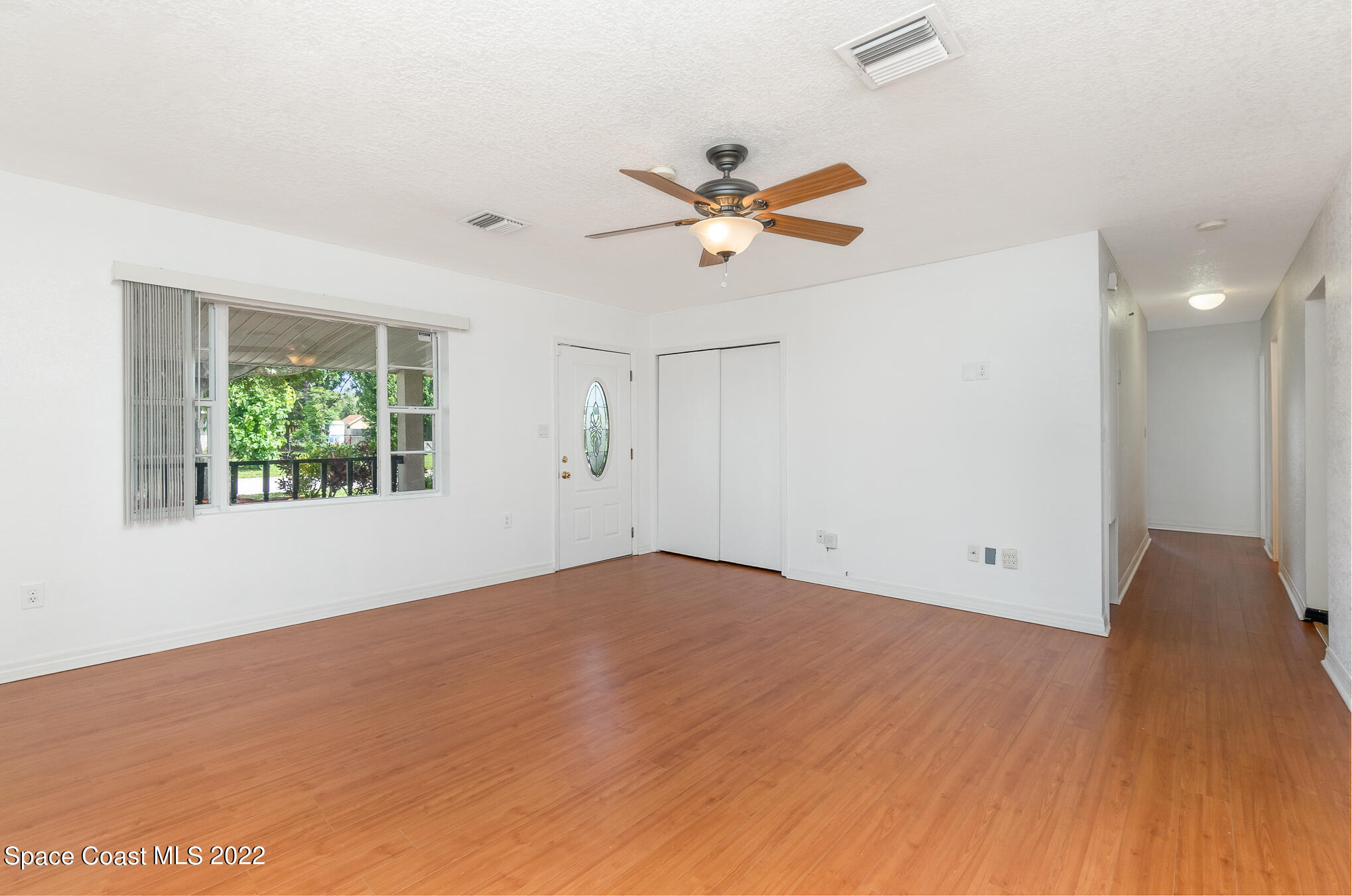 201 Orchid Boulevard Melbourne, FL 32901 - Photo 6 of 36 an empty room with a window and a ceiling fan
