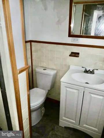 a bathroom with a toilet a sink and a mirror