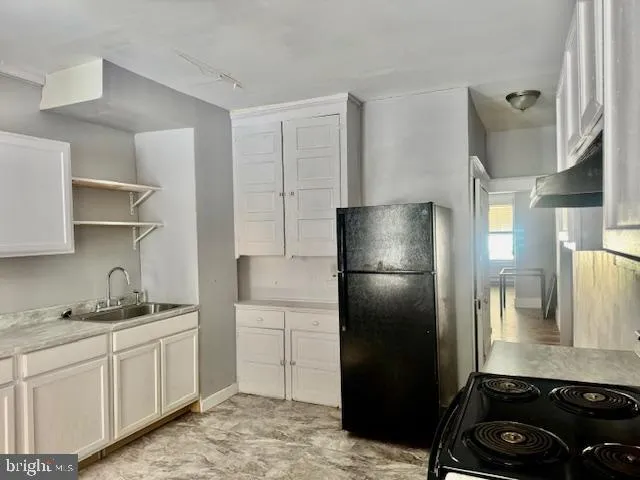 a kitchen with a refrigerator sink and stove