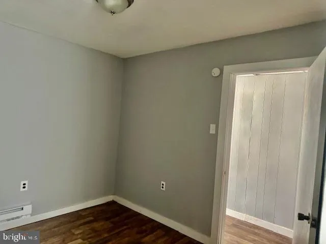 a view of a room with wooden floor and closet
