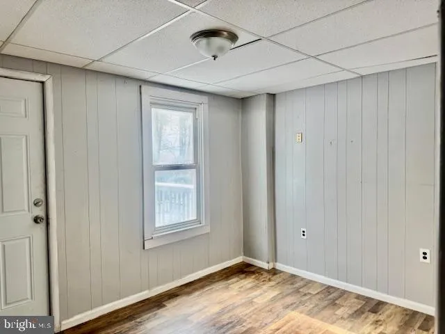 a view of an empty room with window and closet area