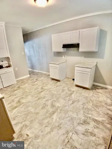 a kitchen with granite countertop a sink and a stove top oven