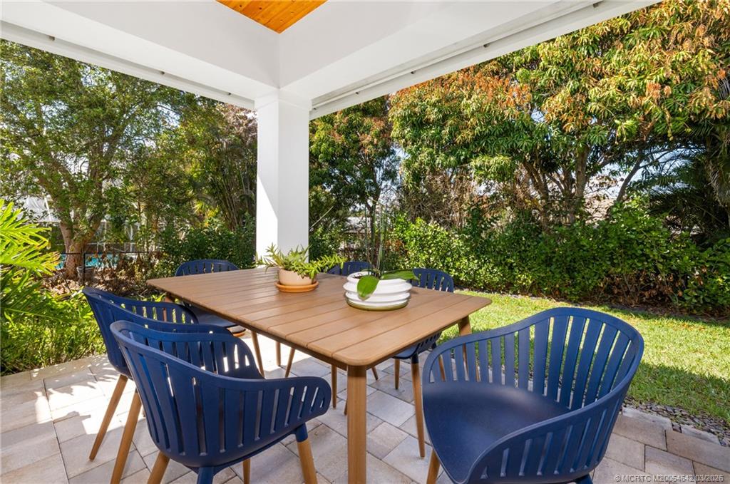 5169 Southeast Horseshoe Point Road Stuart, FL 34997 - Photo 33 of 54 a view of an outside dining space with furniture and wooden floor