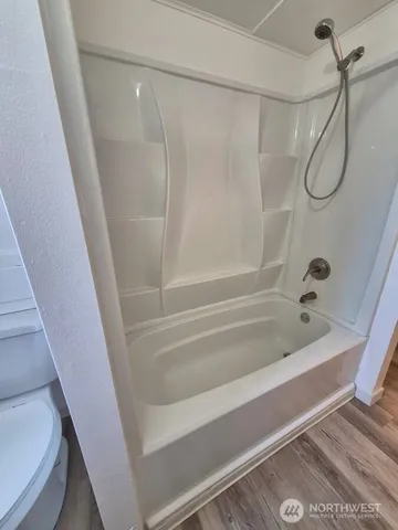 a bathroom with a bath tub and a shower