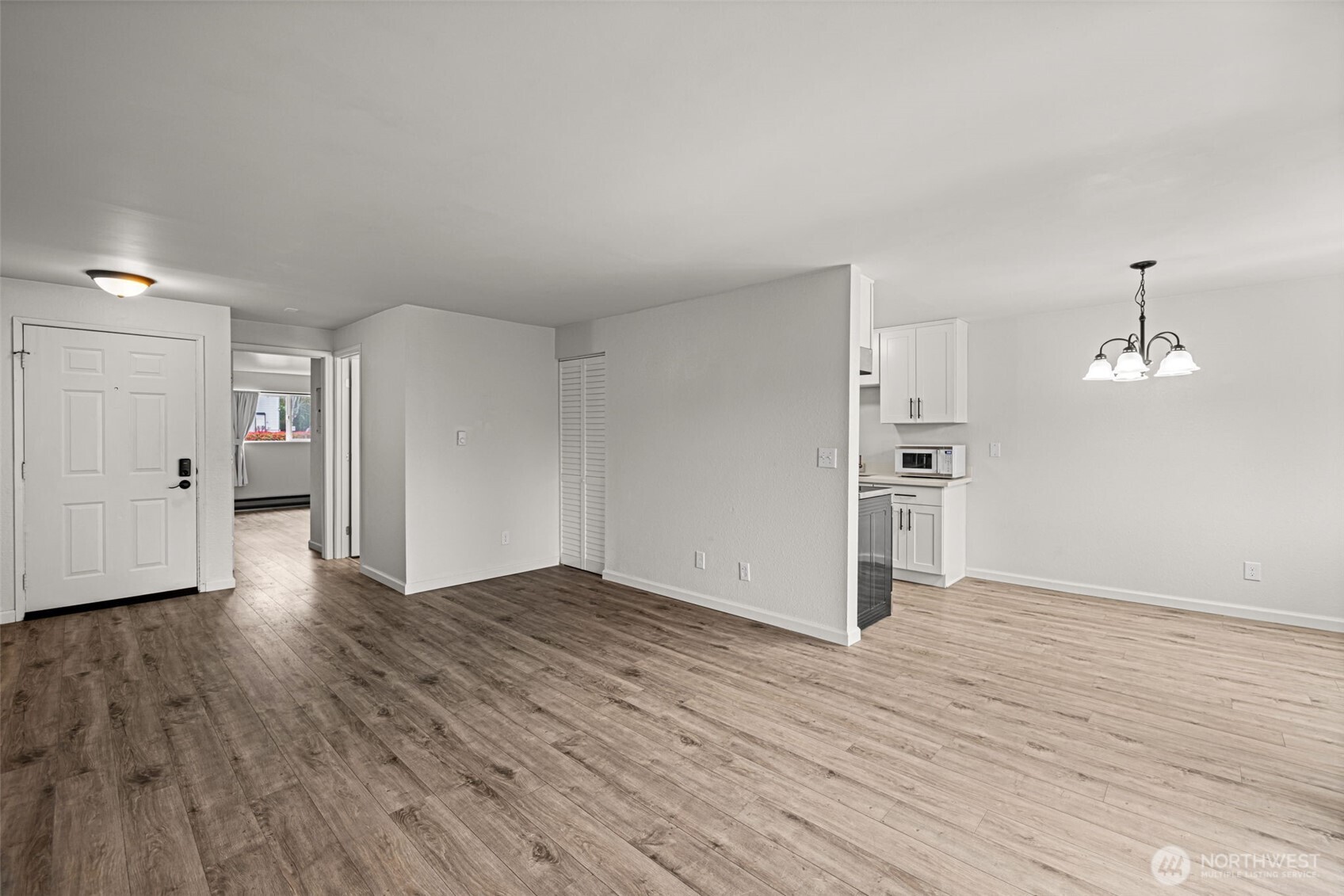 15210 Macadam Road South, Unit D211 Tukwila, WA 98188 - Photo 13 of 26 a view of empty room with wooden floor