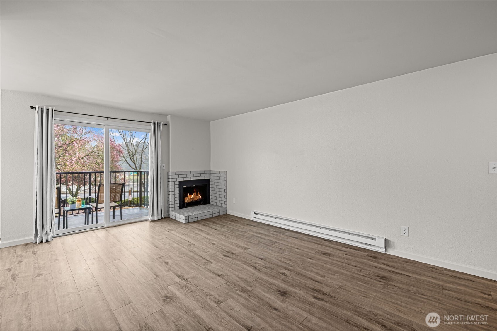 15210 Macadam Road South, Unit D211 Tukwila, WA 98188 - Photo 14 of 26 a view of an empty room with a window and wooden floor