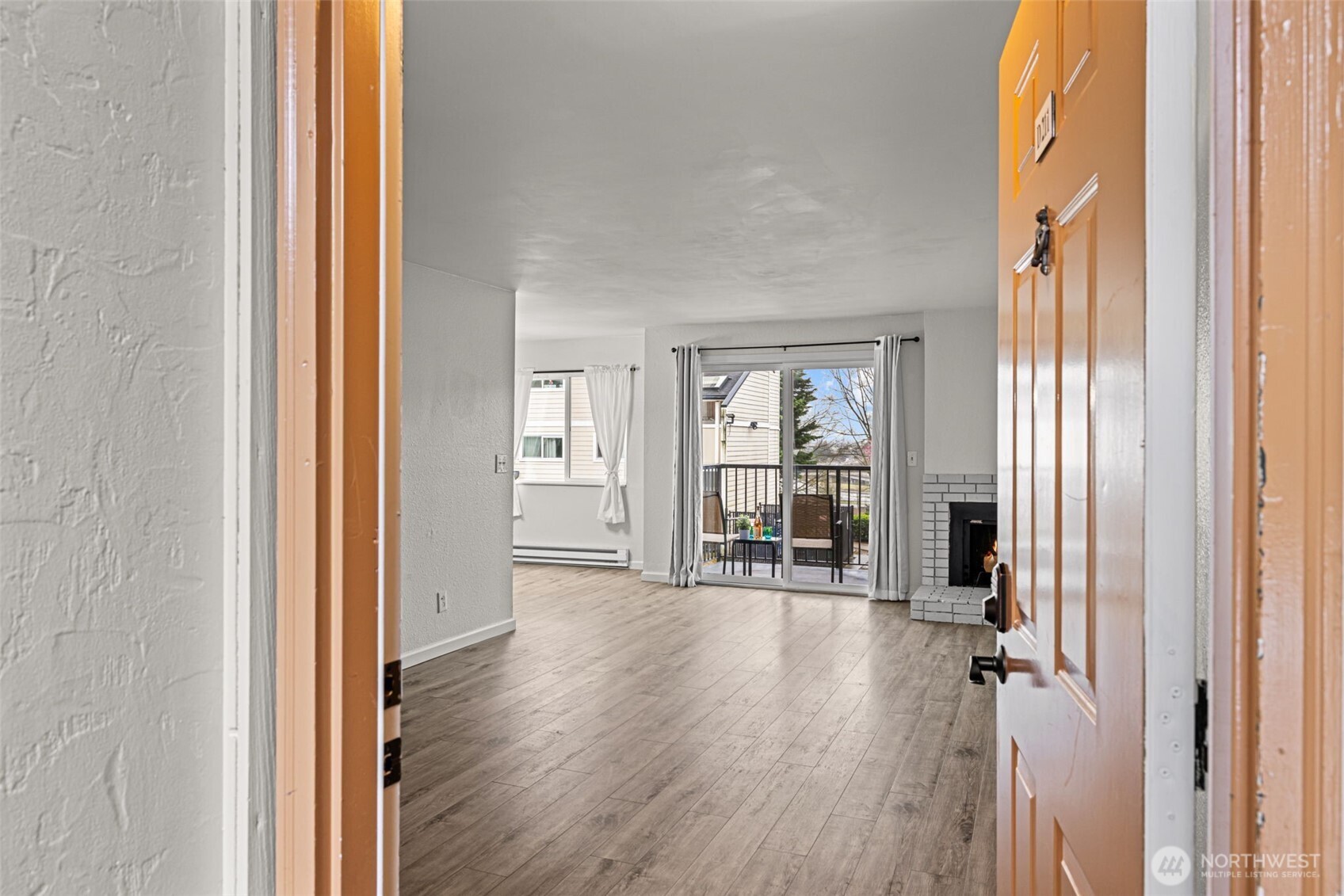 15210 Macadam Road South, Unit D211 Tukwila, WA 98188 - Photo 19 of 26 a view of a room with wooden floor and windows