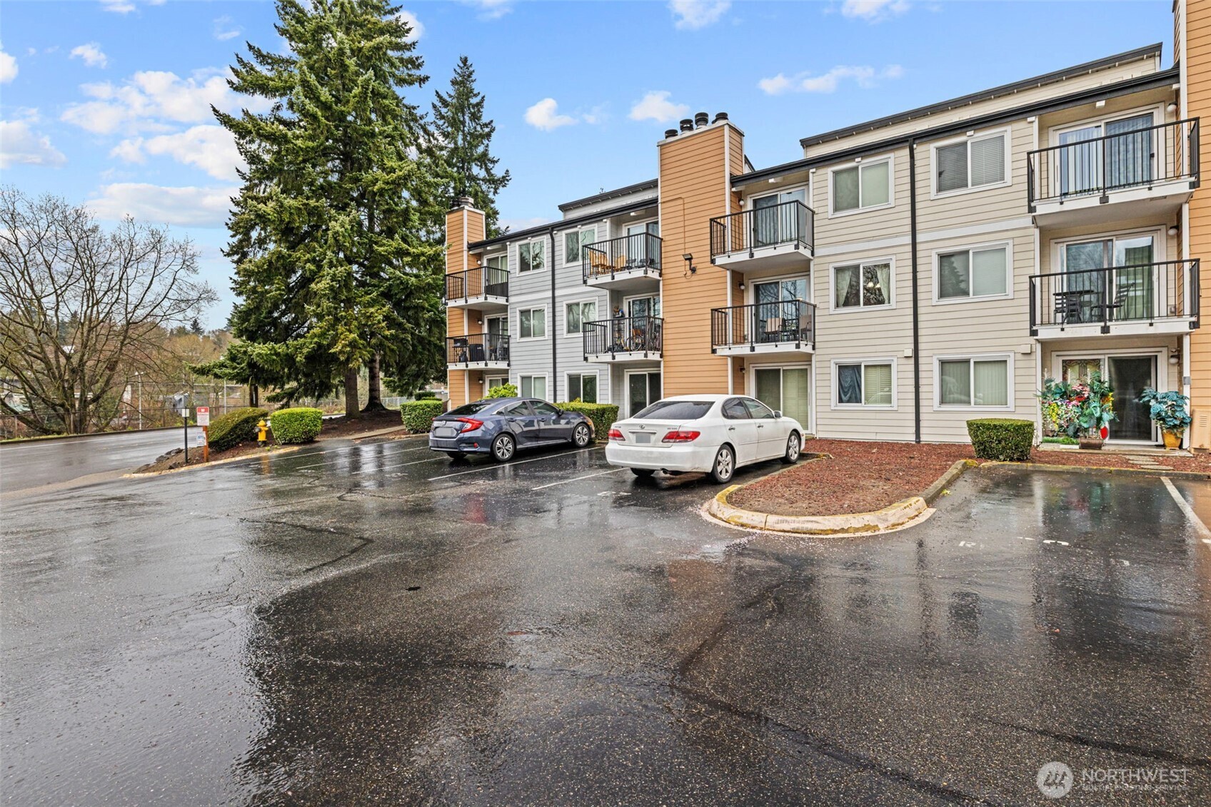 15210 Macadam Road South, Unit D211 Tukwila, WA 98188 - Photo 23 of 26 a buildings with car parked on the roadside