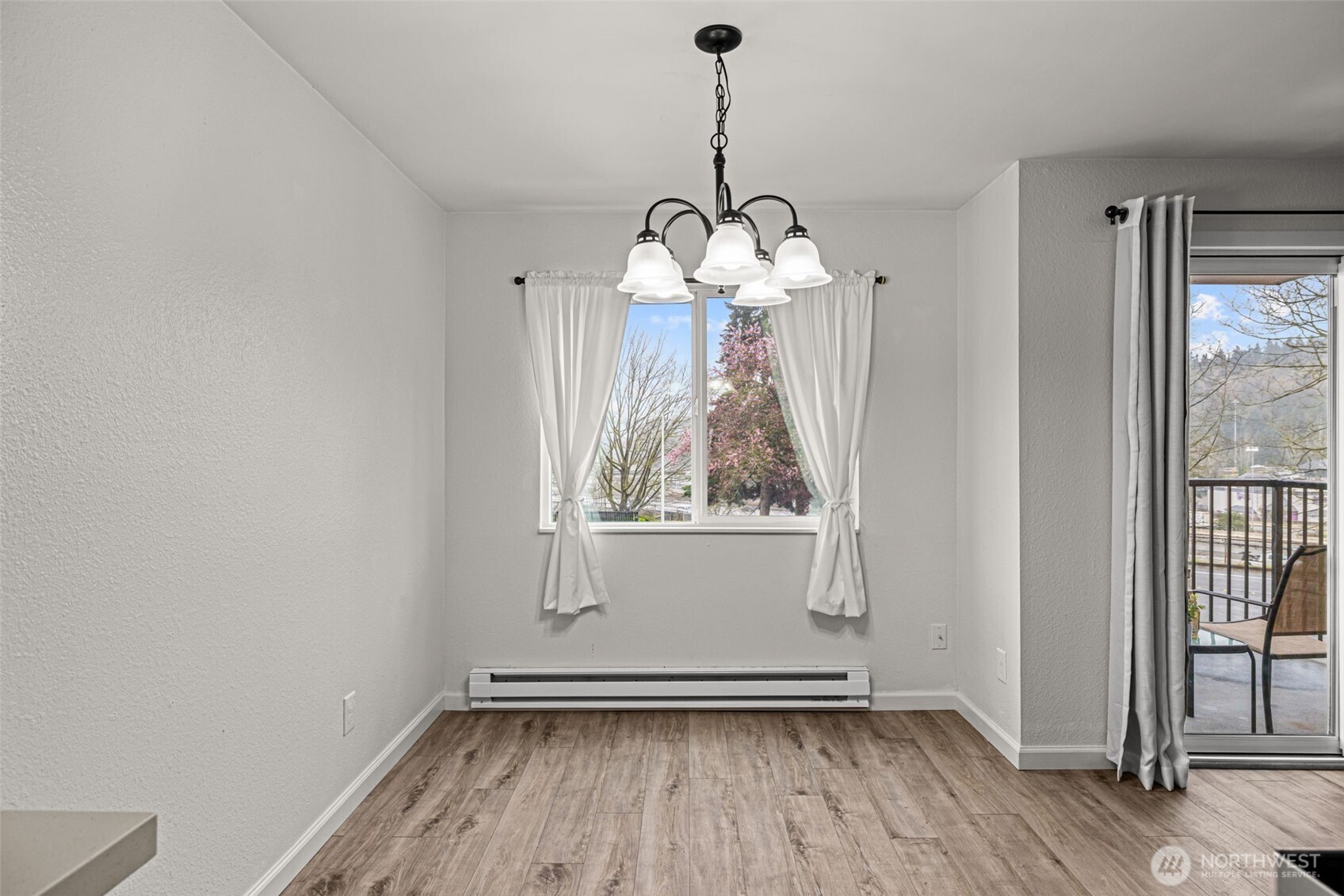 15210 Macadam Road South, Unit D211 Tukwila, WA 98188 - Photo 8 of 26 a view of a room with wooden floor a chandelier