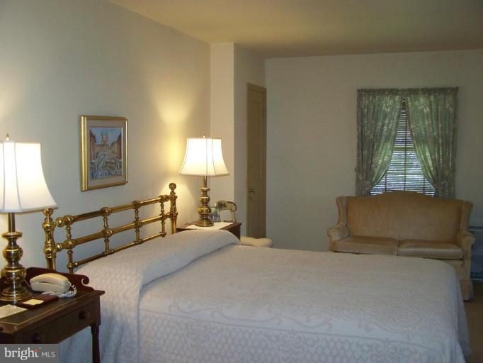 607 Coventry Road Towson, MD 21286 - Photo 11 of 19 a bedroom with a bed and a lamp