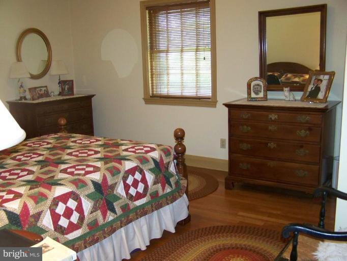 607 Coventry Road Towson, MD 21286 - Photo 13 of 19 a bedroom with a bed and wooden floor