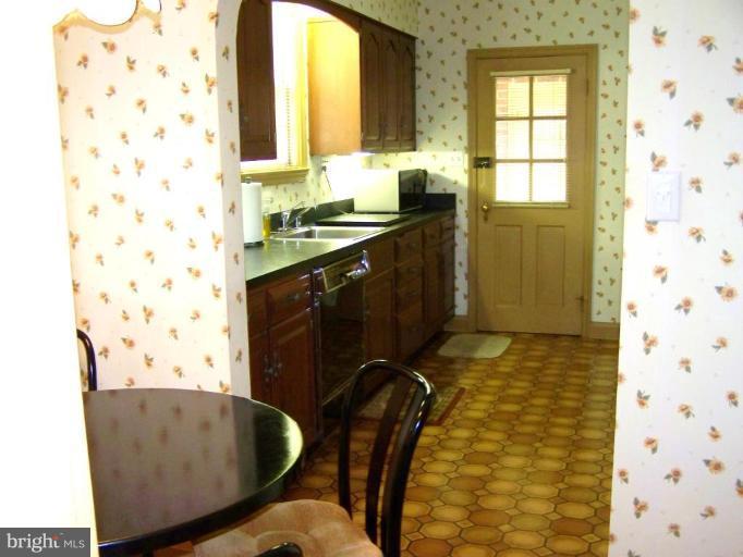 607 Coventry Road Towson, MD 21286 - Photo 6 of 19 a bathroom with a granite countertop sink a toilet and shower