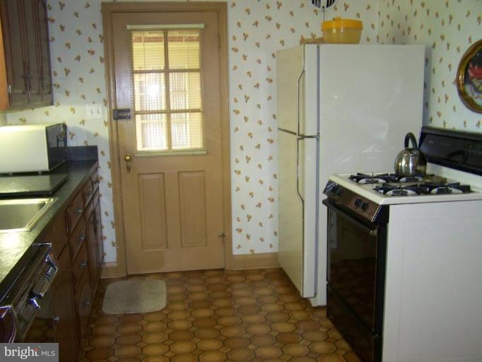 607 Coventry Road Towson, MD 21286 - Photo 7 of 19 a kitchen with stainless steel appliances granite countertop a refrigerator and a stove