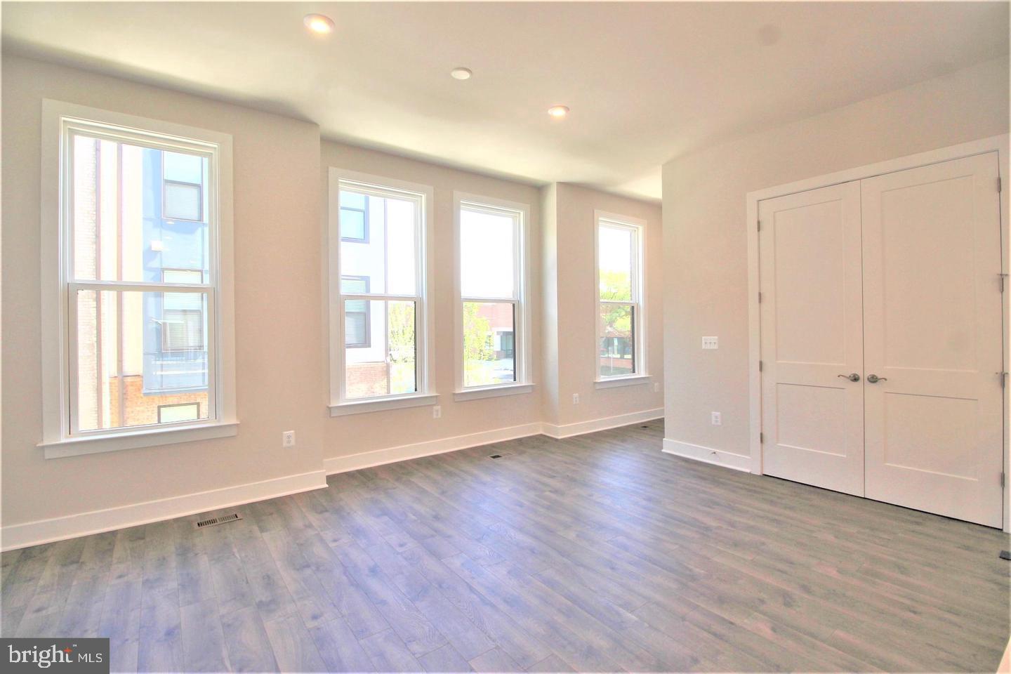 2471 Liberty Loop Herndon, VA 20171 - Photo 12 of 35 a view of an empty room with wooden floor and a window