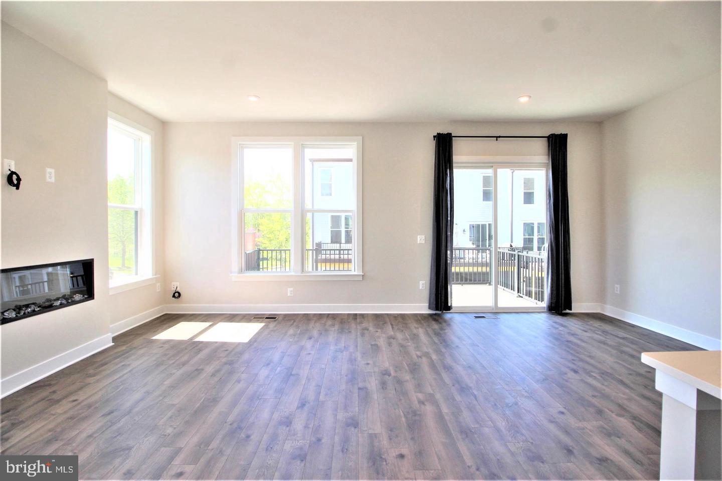 2471 Liberty Loop Herndon, VA 20171 - Photo 15 of 35 an empty room with wooden floor and windows
