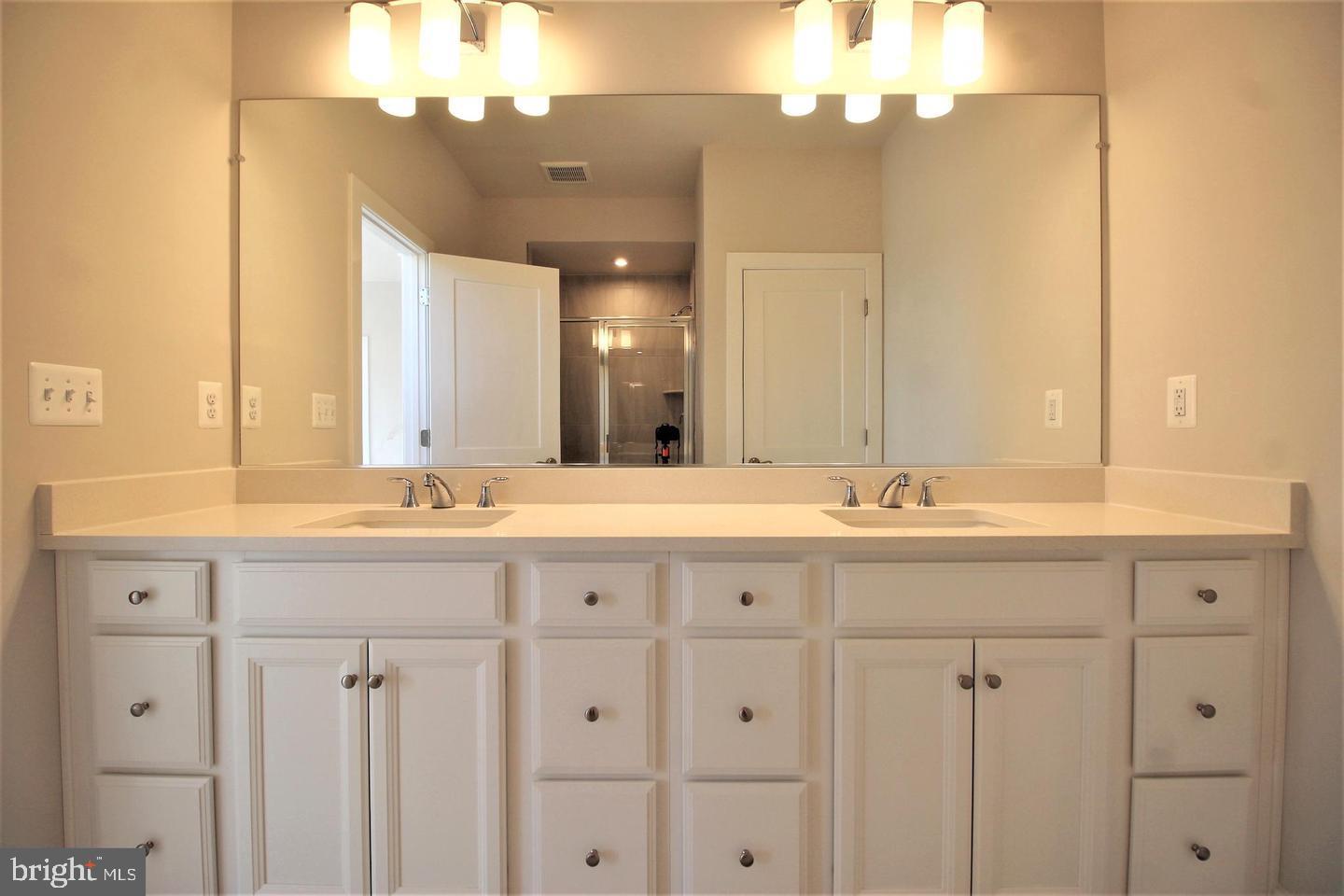 2471 Liberty Loop Herndon, VA 20171 - Photo 21 of 35 a bathroom with double sink and a mirror
