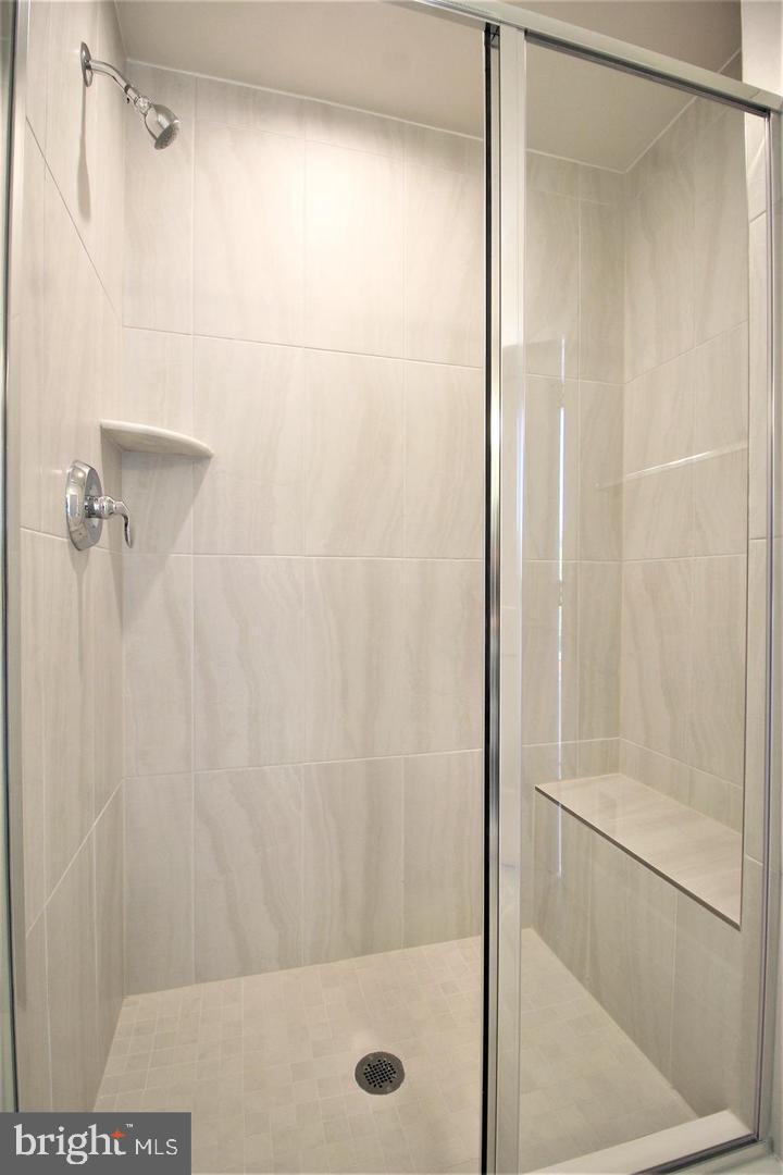 2471 Liberty Loop Herndon, VA 20171 - Photo 22 of 35 a bathroom with a glass shower door