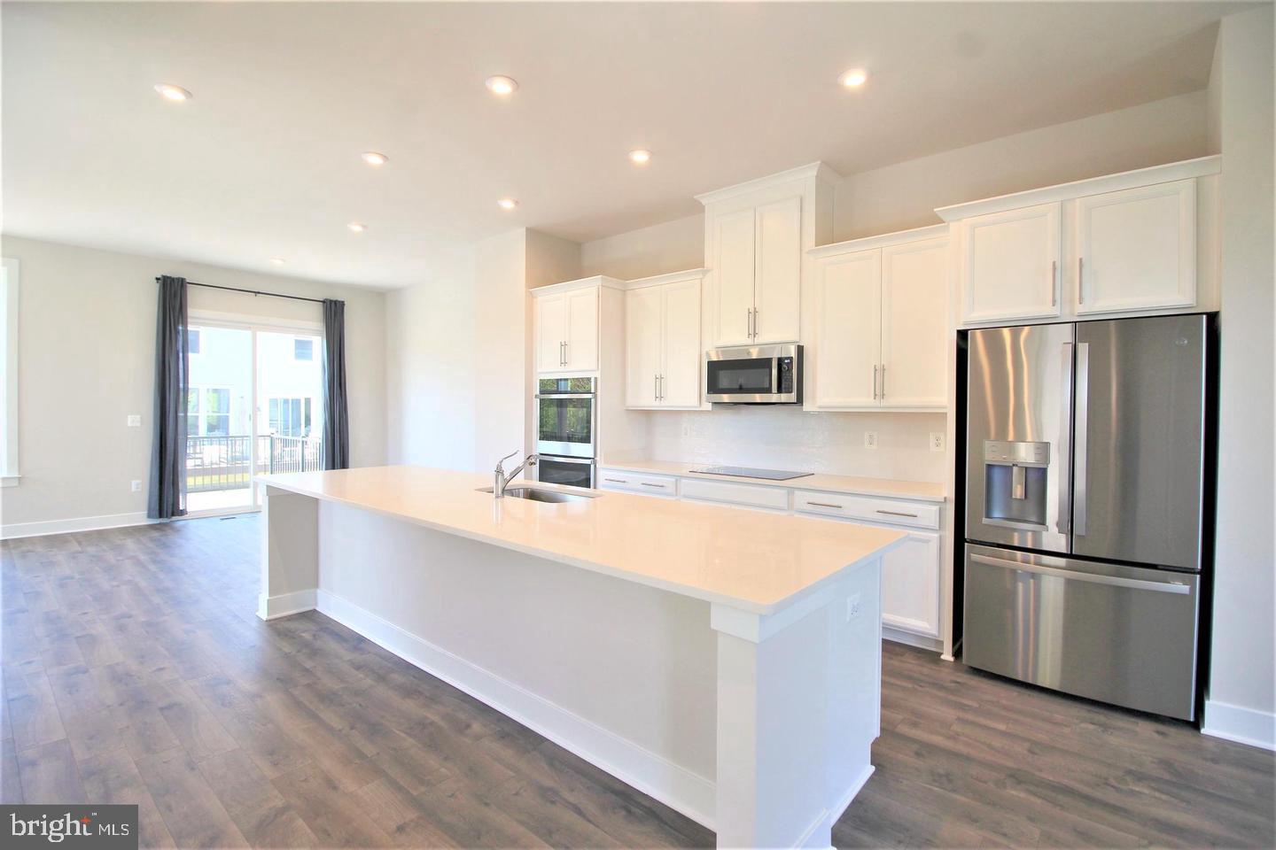 2471 Liberty Loop Herndon, VA 20171 - Photo 35 of 35 a large kitchen with stainless steel appliances a refrigerator and a stove top oven