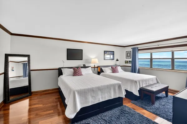 a bedroom with double bed and a large window