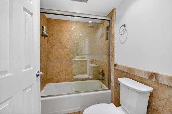 a bathroom with a shower and a toilet